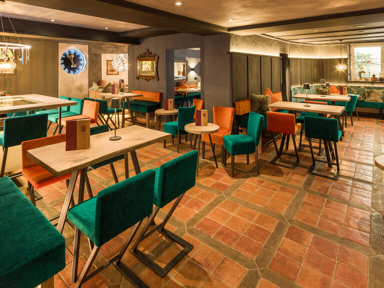 Viele Tische und Stühle füllen den modernen Sitzbereich der Bar "Alte Küche"